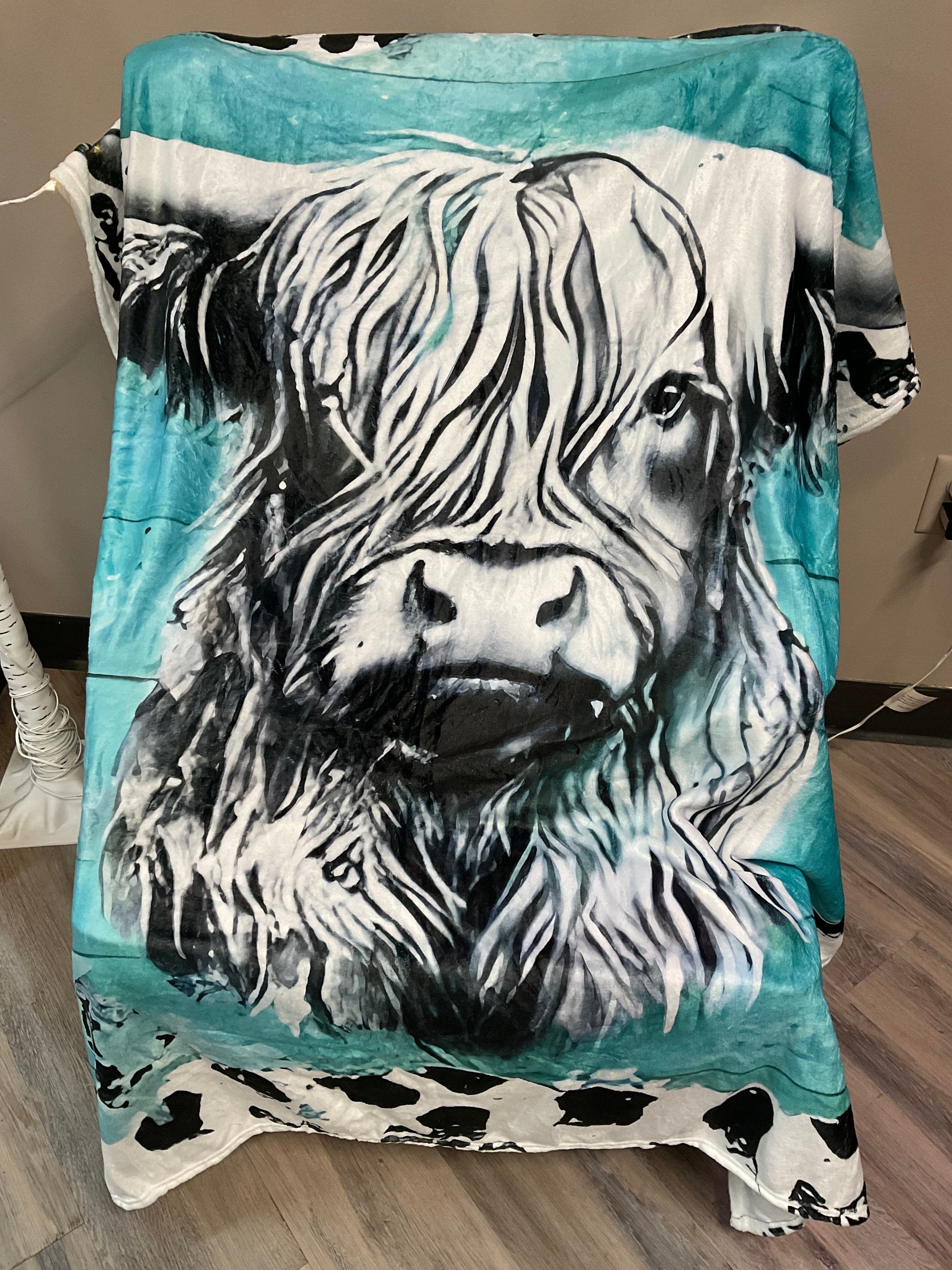 Turquoise plush cow blanket